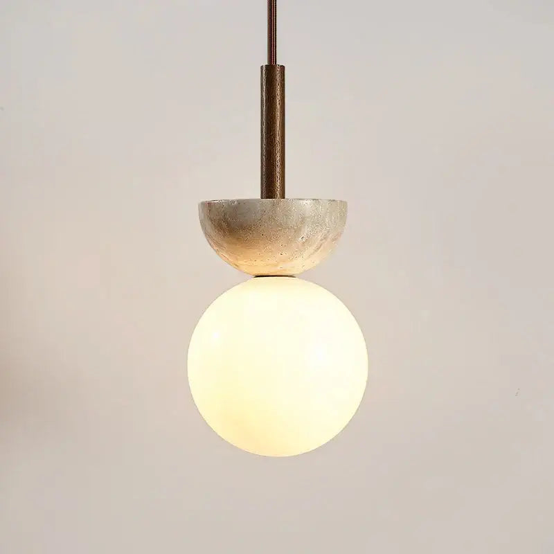 A modern decorbites led pendant light featuring a matte concrete half-sphere and frosted glass globe suspended by dark metal rod
