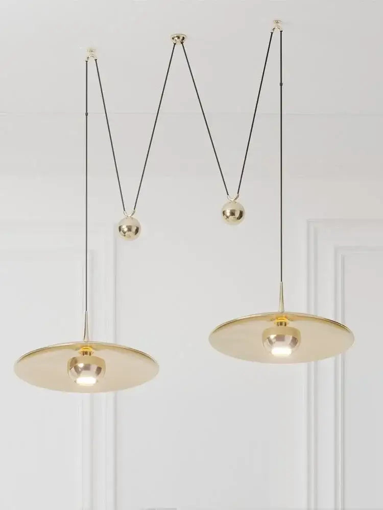 Gold-toned DecorBites™ LED pendant lighting with sleek circular shades and adjustable black cords for bedroom and dining room