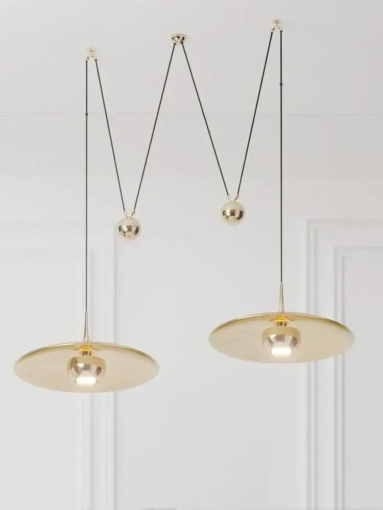 Gold-toned DecorBites LED pendant lighting lamp with minimalist circular shades and adjustable black cords for bedroom use