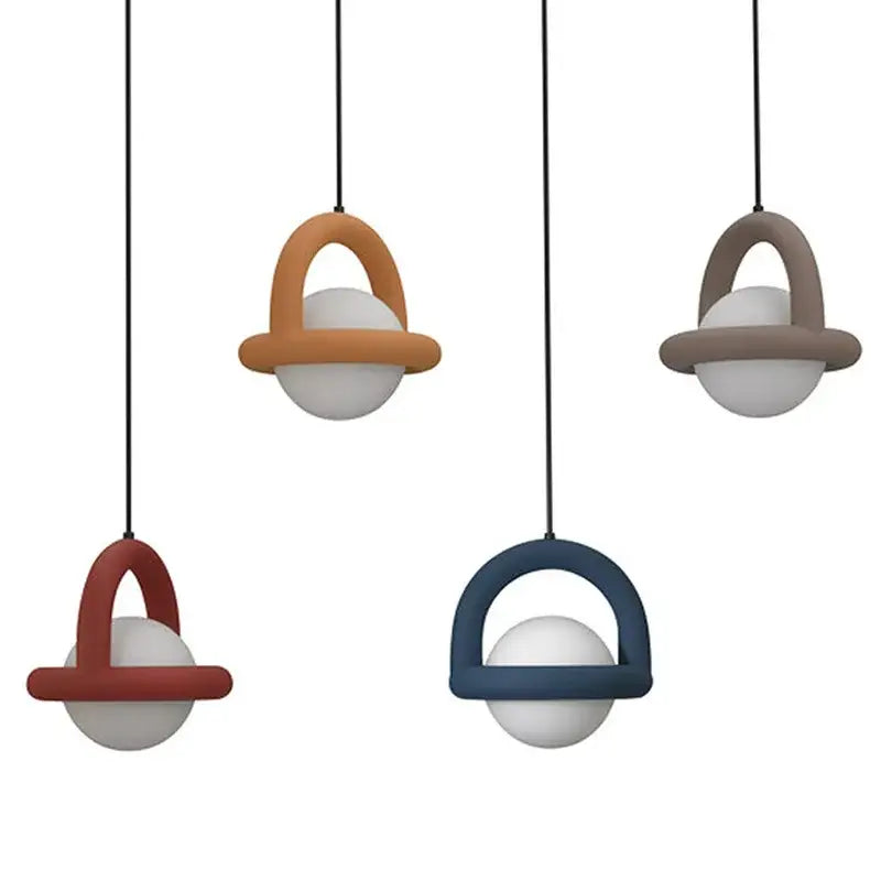 Modern DecorBites™ LED pendant lights featuring matte earth-toned metal arches and white acrylic spheres for dining rooms