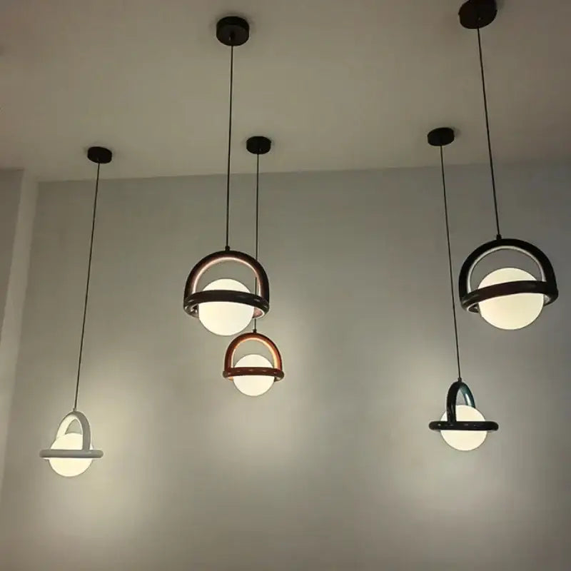 Modern DecorBites LED pendant lights with black and copper metal frames and acrylic ball bulbs for dining room