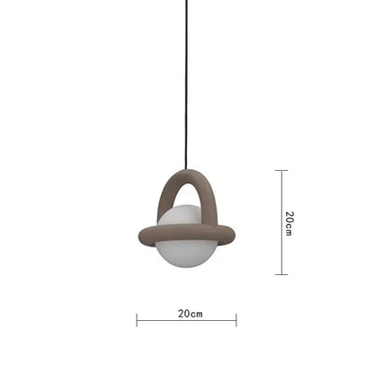 A minimalist decorbites led pendant light with a matte taupe acrylic ball and metal wire for dining room use