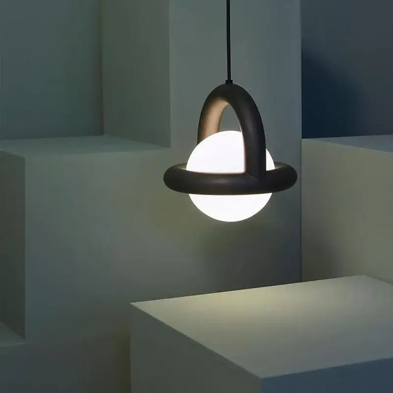 Black matte DecorBites LED pendant light with glowing acrylic ball encircled by metal wire for dining or bedroom