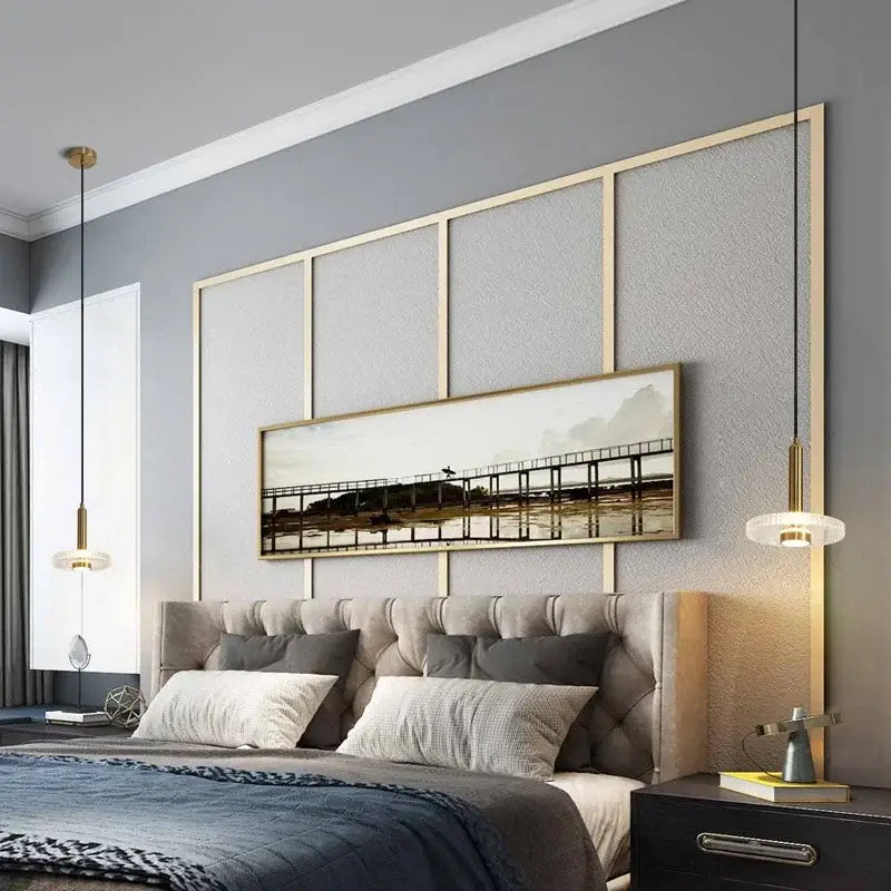 Long rectangular framed painting with muted earth tones above bed complementing decorbites led pendant lights in gold frame