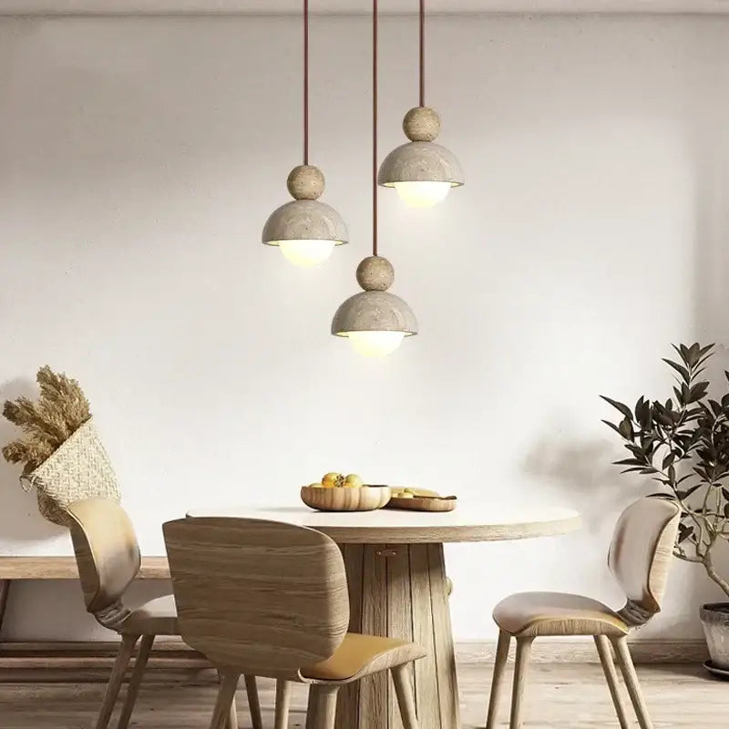 Three matte concrete pendant lights with spherical accents from DecorBites LED pendant for dining rooms and restaurants