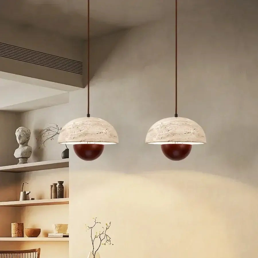 Two decorbites led pendant lights with white marble domes and deep red bases hang as elegant pendant lights bar decor