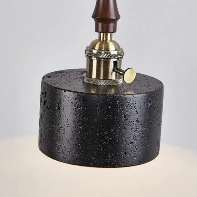 Black textured concrete lamp base with brass socket and dark wood stem for decorbites led pendant black travertine light