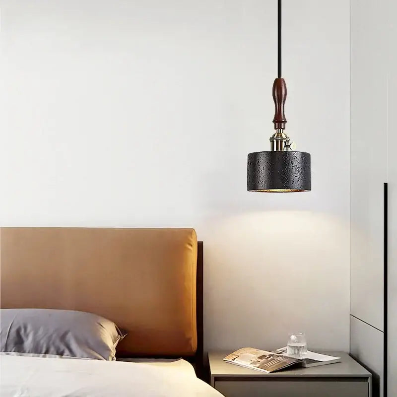 Black textured cylindrical pendant light with dark wood handle by DecorBites led pendant in black travertine finish