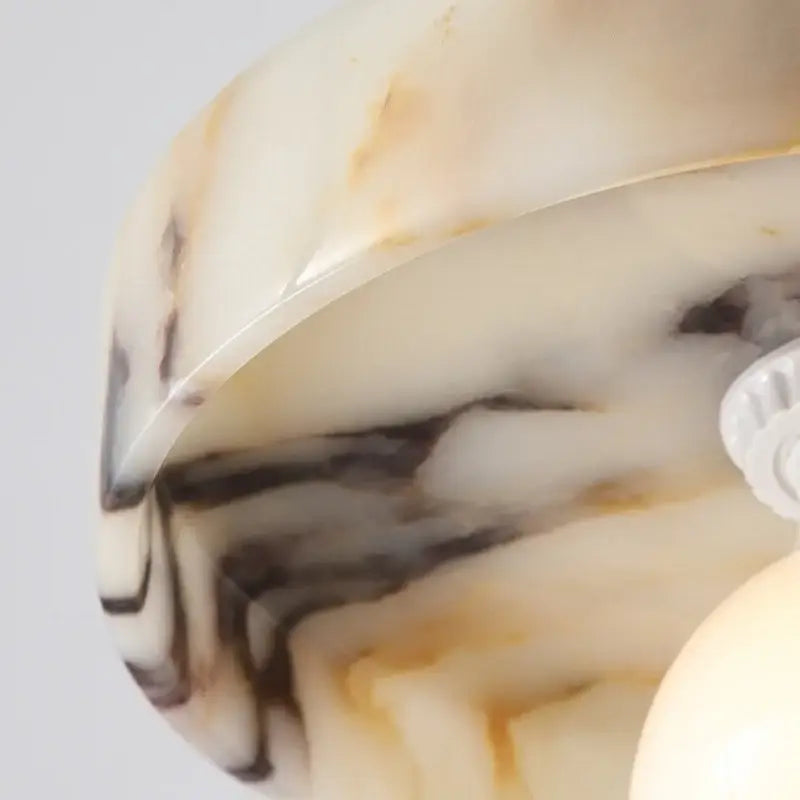 A polished curved marble lamp base with cream black and golden brown veining for decorbites led pendant lights bulgari