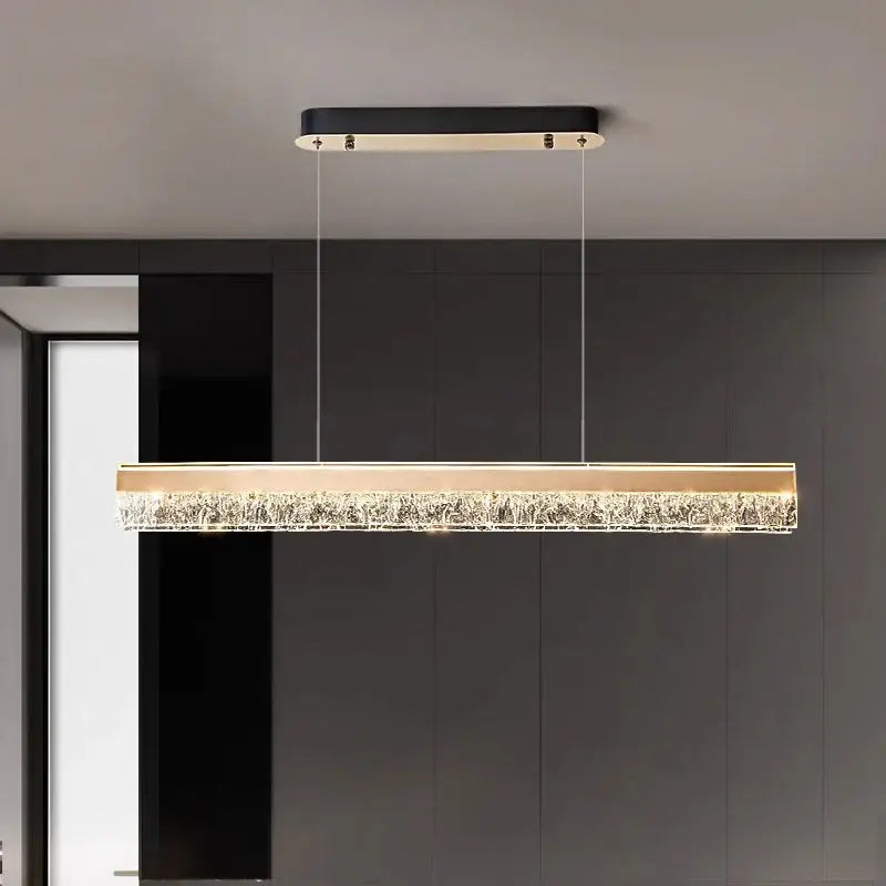 Modern decorbites led pendant lights featuring a black top and gold frame with illuminated crystal lower section