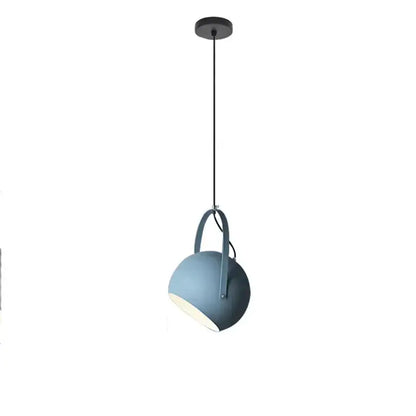A sleek matte blue spherical decorbites led pendant light with minimalist design and black hanging cord for dining areas