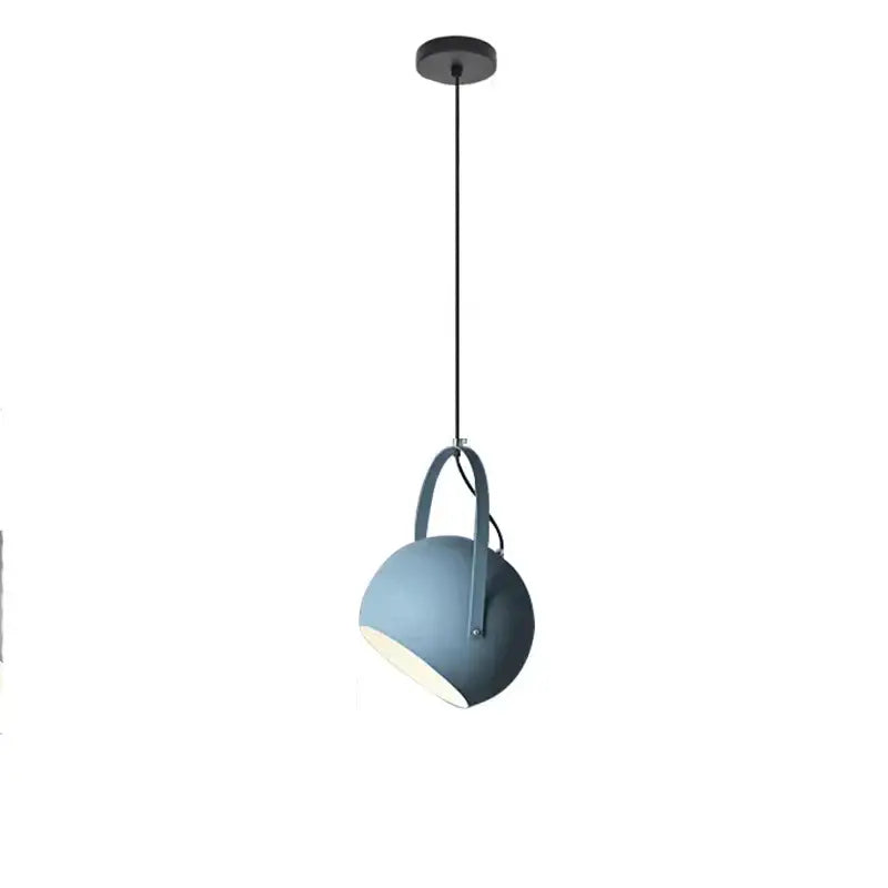 A sleek matte blue spherical decorbites led pendant light with minimalist design and black hanging cord for dining areas
