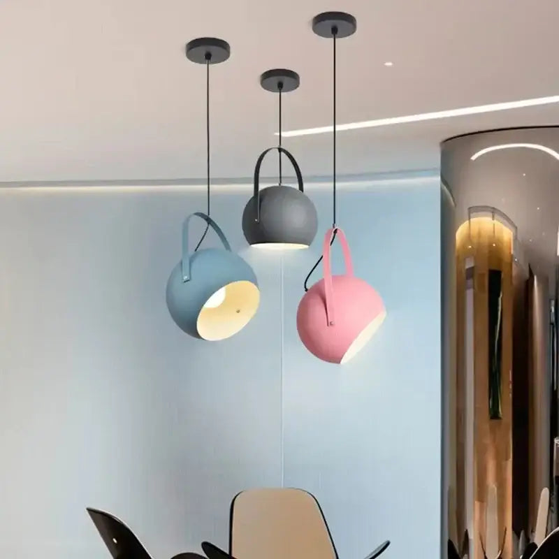 Three modern decorbites led pendant lights with matte blue gray and pink spherical shades for dining decor lighting
