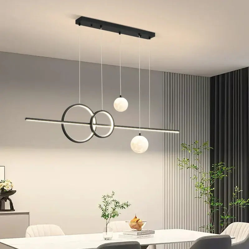 Modern black and white decorbites led pendant lights with sleek circular rings and spherical bulbs for dining room lighting