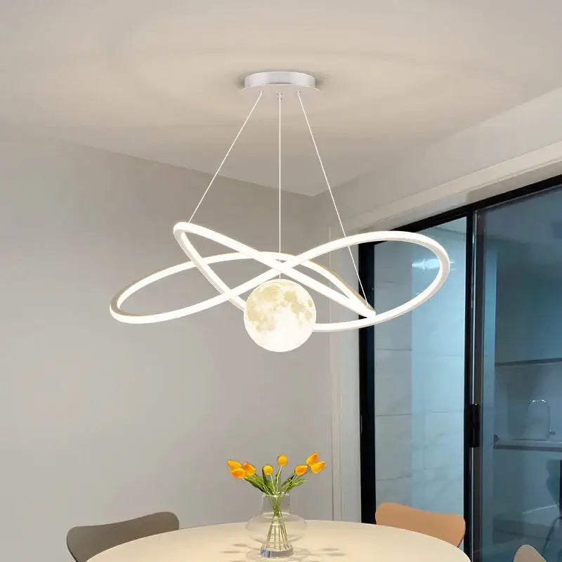 Modern white DecorBites LED pendant lights with intertwined circular rings and a glowing moon pendant for indoor use
