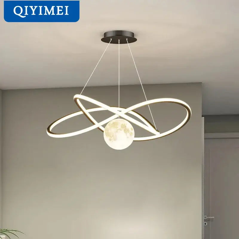 Modern minimalist DecorBites LED pendant lights with interlocking glowing rings and central moon-shaped bulb in metallic finish