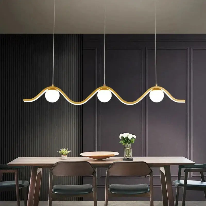 Gold-toned wave-shaped decorbites led pendant light with three white spherical bulbs for modern indoor lighting