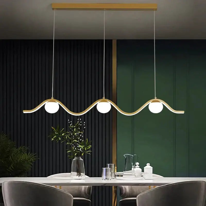Modern gold-toned decorbites led pendant light with three spherical bulbs and wavy minimalist design for indoor lighting
