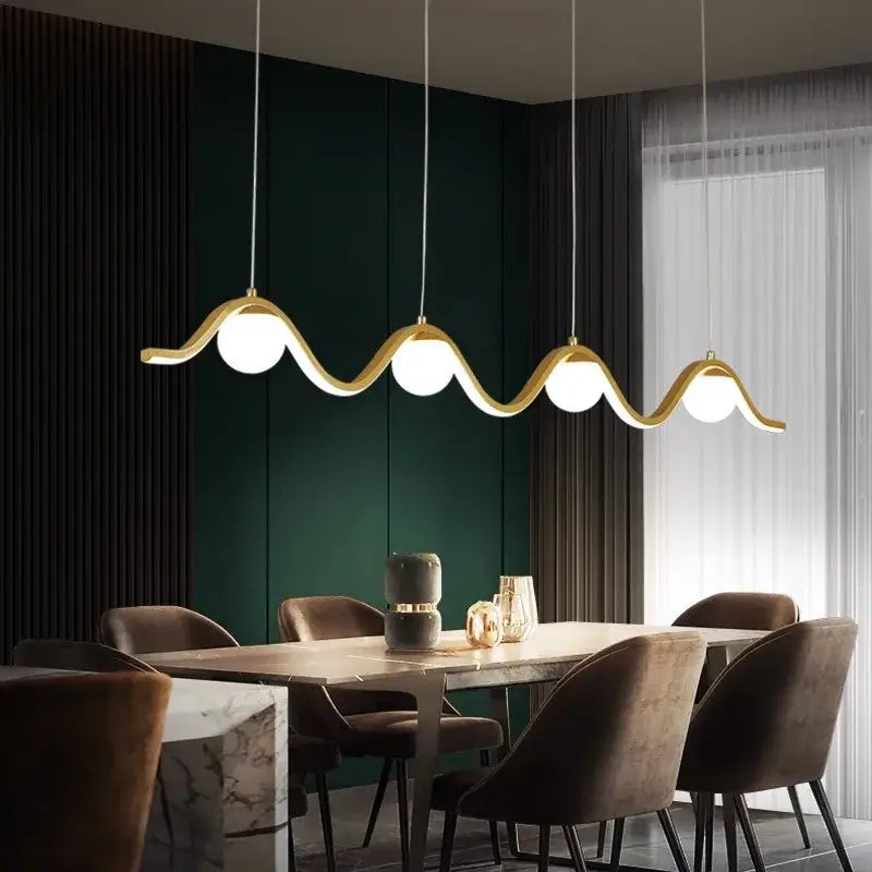 Gold-toned DecorBites LED pendant lights with wavy design and four spherical bulbs for modern indoor lighting