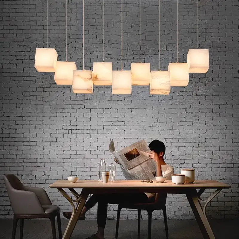 Modern decorbites led pendant lights featuring multiple warm-toned alabaster-like square shades for indoor use