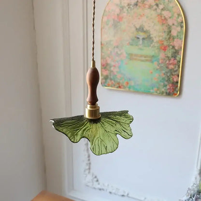 DecorBites led pendant featuring a green glass leaf design with copper socket and walnut wood handle in Nordic modern style