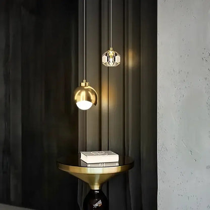 Two elegant decorbites led pendant lights with a polished gold sphere and faceted crystal design for luxury decor