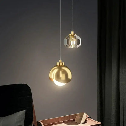 Two decorbites led pendant lights featuring a polished gold sphere and faceted crystal design for luxury decor