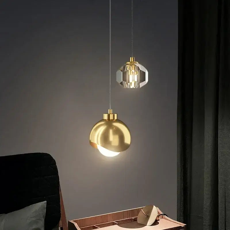 Two decorbites led pendant lights featuring a polished gold sphere and faceted crystal design for luxury decor