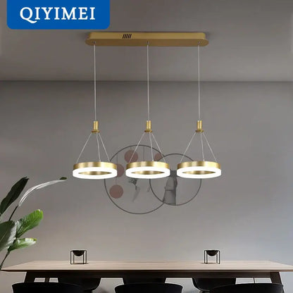 Gold-toned DecorBites led pendant lights with three circular rings suspended from a rectangular ceiling mount