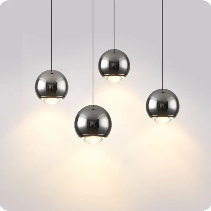 Set of four sleek brushed chrome spherical decorbites led pendant lights with warm led illumination for modern interiors