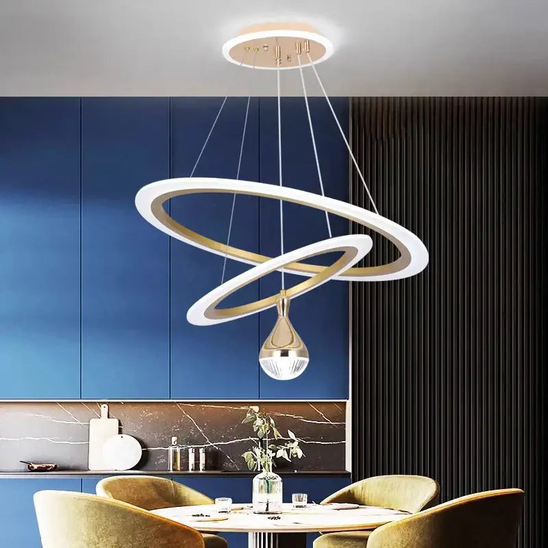 Modern décorbites led pendant lights with white and gold metallic double rings suspended above dining table