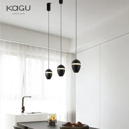 Black DecorBites LED pendant lights with gold accent rings suspended by thin cords for modern ceiling lighting