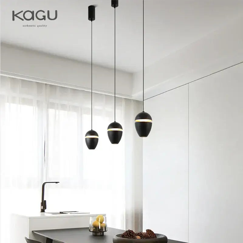 Black DecorBites LED pendant lights with gold accent rings suspended by thin cords for modern ceiling lighting