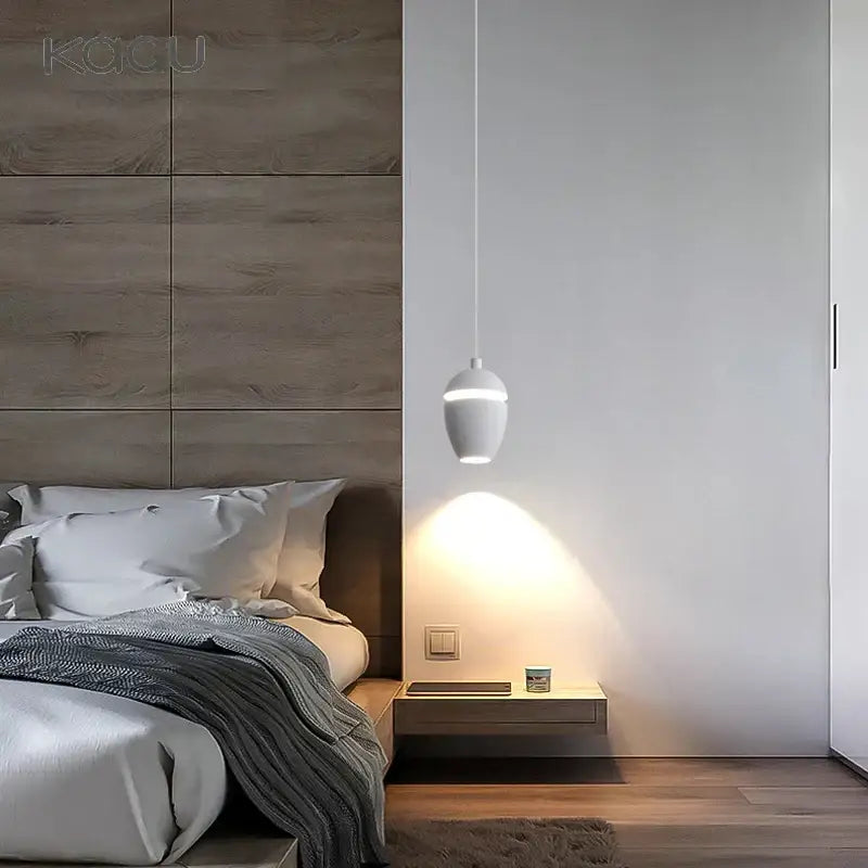White sleek decorbites led pendant light with modern circular design hanging above minimalist bedside table