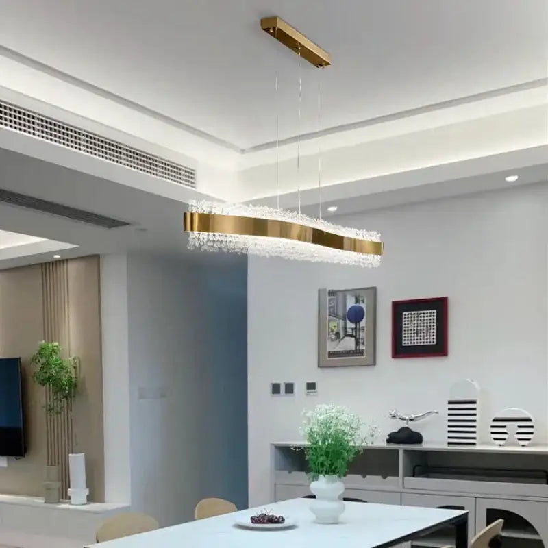 Gold-toned rectangular decorbites led pendant light with embedded crystals reflecting light for modern interiors
