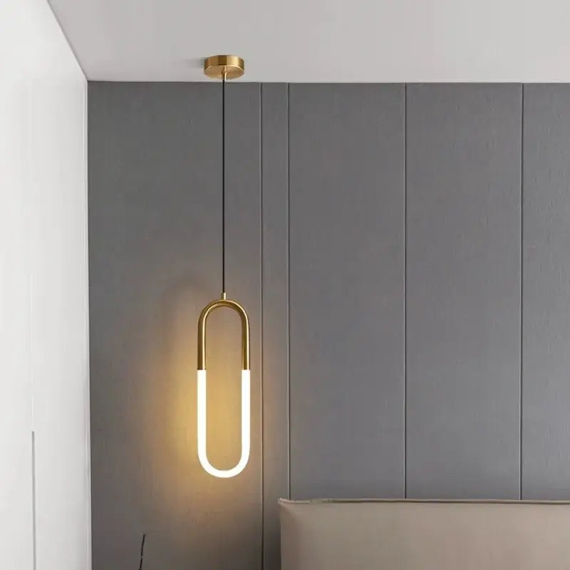 Gold-toned u-shaped DecorBites LED pendant lights with sleek modern design and warm LED illumination for indoor use