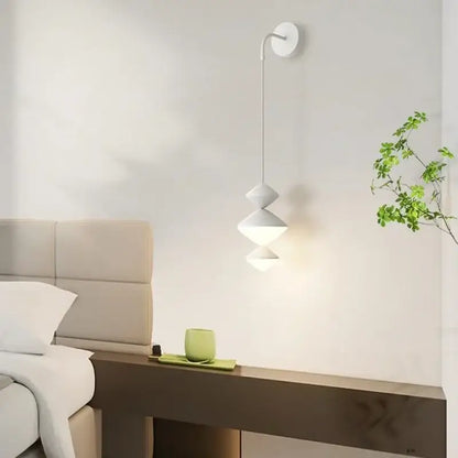 A modern white DecorBites led pendant light with stacked cone shades for minimalist bedroom and living room lighting