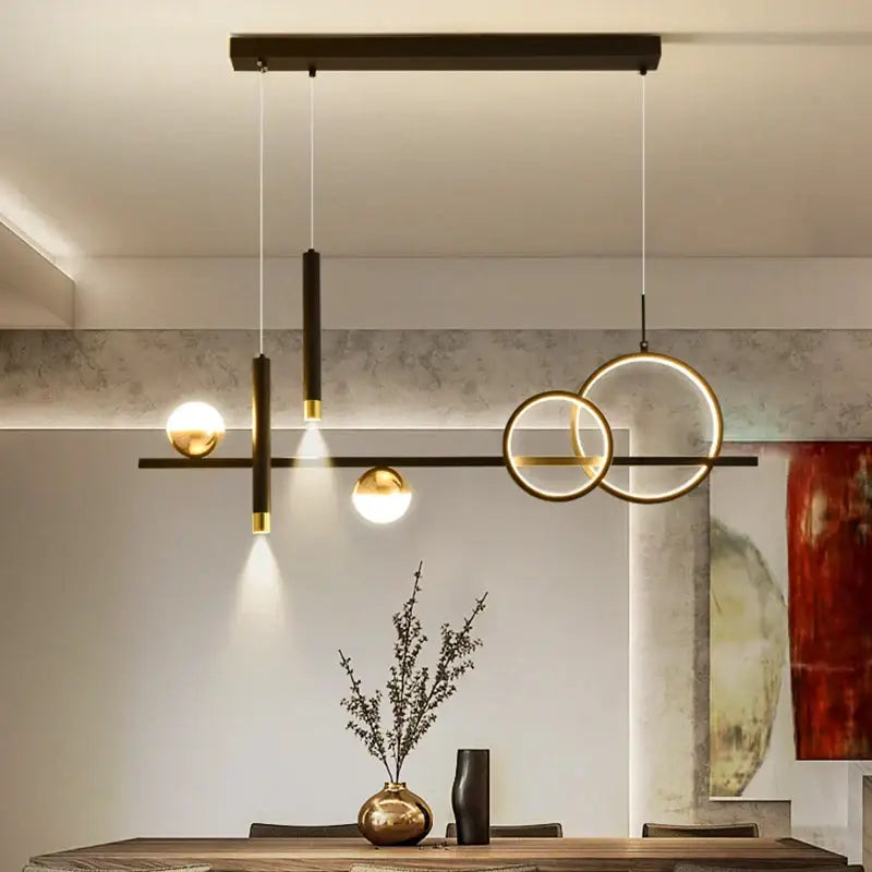 Modern geometric decorbites led pendant lights with black and gold accents and spherical bulbs for kitchen lighting