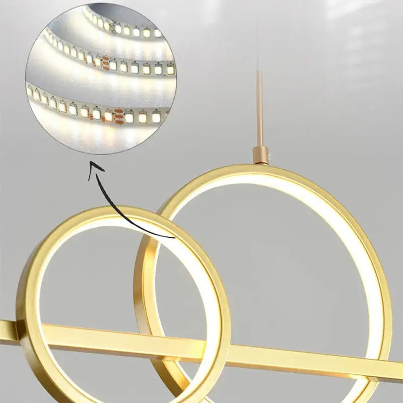 Modern gold-toned decorbites led pendant light with circular design and integrated led strip lighting for kitchens and offices