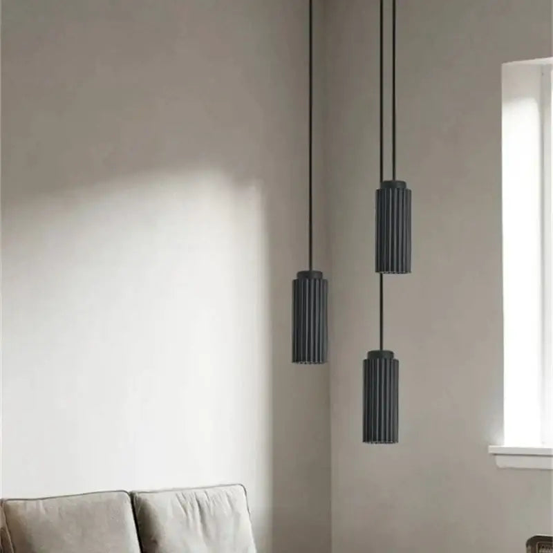 Three sleek dark gray cylindrical decorbites led pendant lights with vertical ridges for bedroom and kitchen use