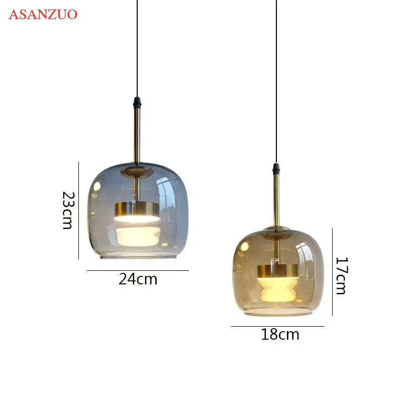 Decorbites led pendant lights featuring two frosted glass shades in muted blue-gray and amber with brass rods