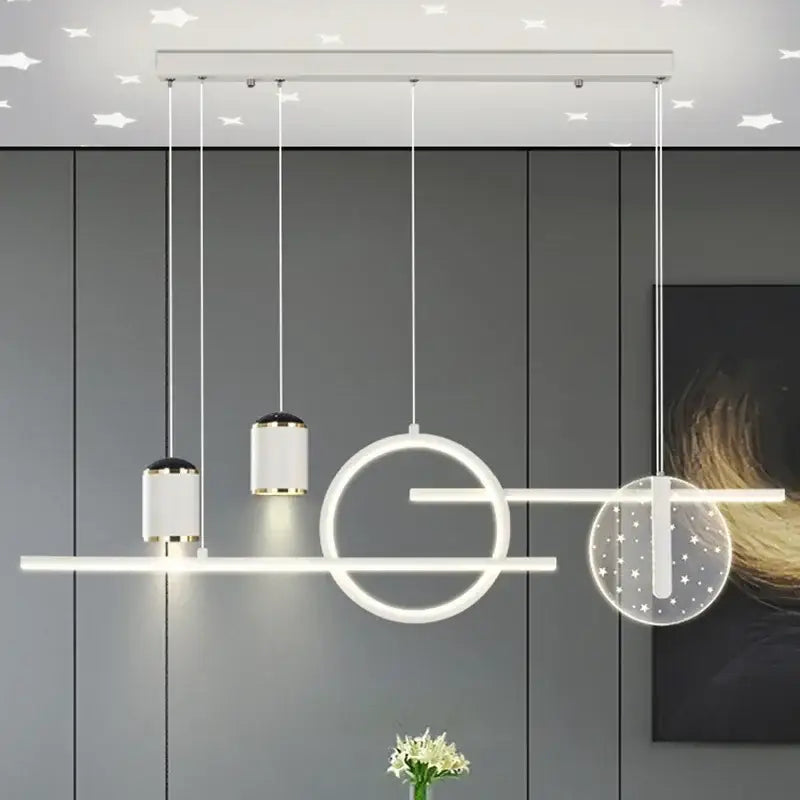 Modern white led pendant lights with geometric cylindrical and circular fixtures accented by gold trim by DecorBites