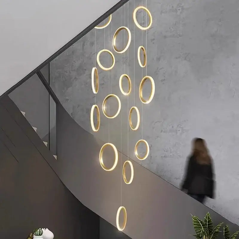 Golden circular decorbites led pendant lights in a modern interior for living room dining area and staircase chandelier
