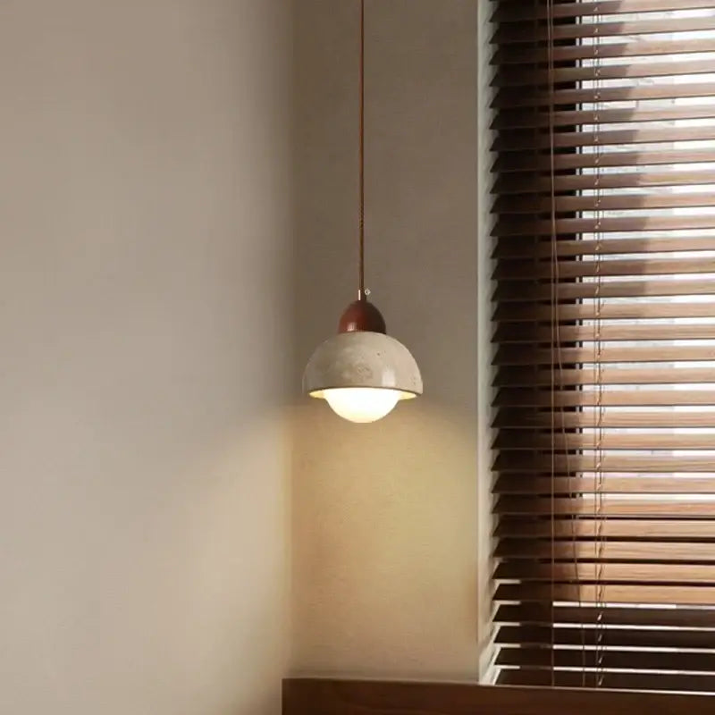 A warm-toned ceramic decorbites led pendant light with matte finish and copper fixture for living room and kitchen