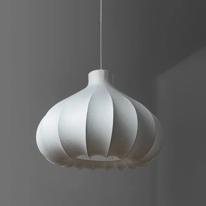 A white textured DecorBites led pendant light with a segmented bulbous design hanging from a thin cord