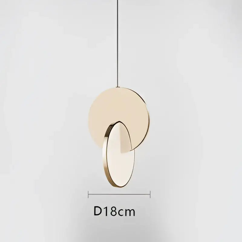 A modern decorbites led pendant light with two overlapping matte gold and transparent glass discs for home decoration