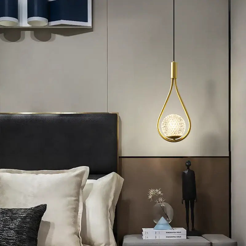 Gold-toned decorbites led pendant light featuring a textured illuminated glass globe with g9 bulb for indoor use