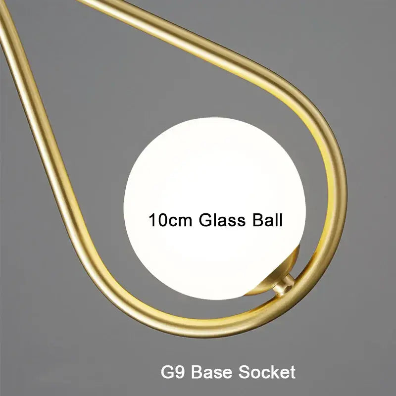 A sleek gold-toned metal frame cradling a 10cm clear glass ball with g9 socket in decorbites led pendant lights