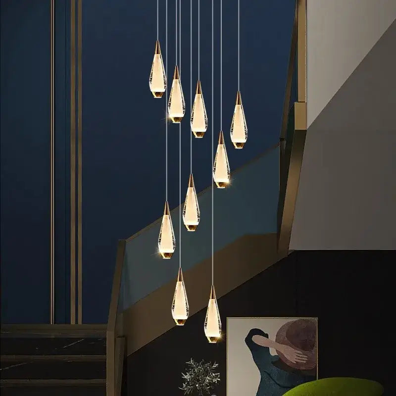 Elegant teardrop-shaped crystal decorbites led pendant lights with gold caps hanging in modern led pendant staircase chandelier
