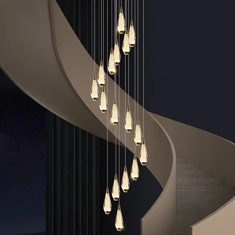 A modern decorbites led pendant chandelier with cascading teardrop glass pendants for indoor staircase lighting